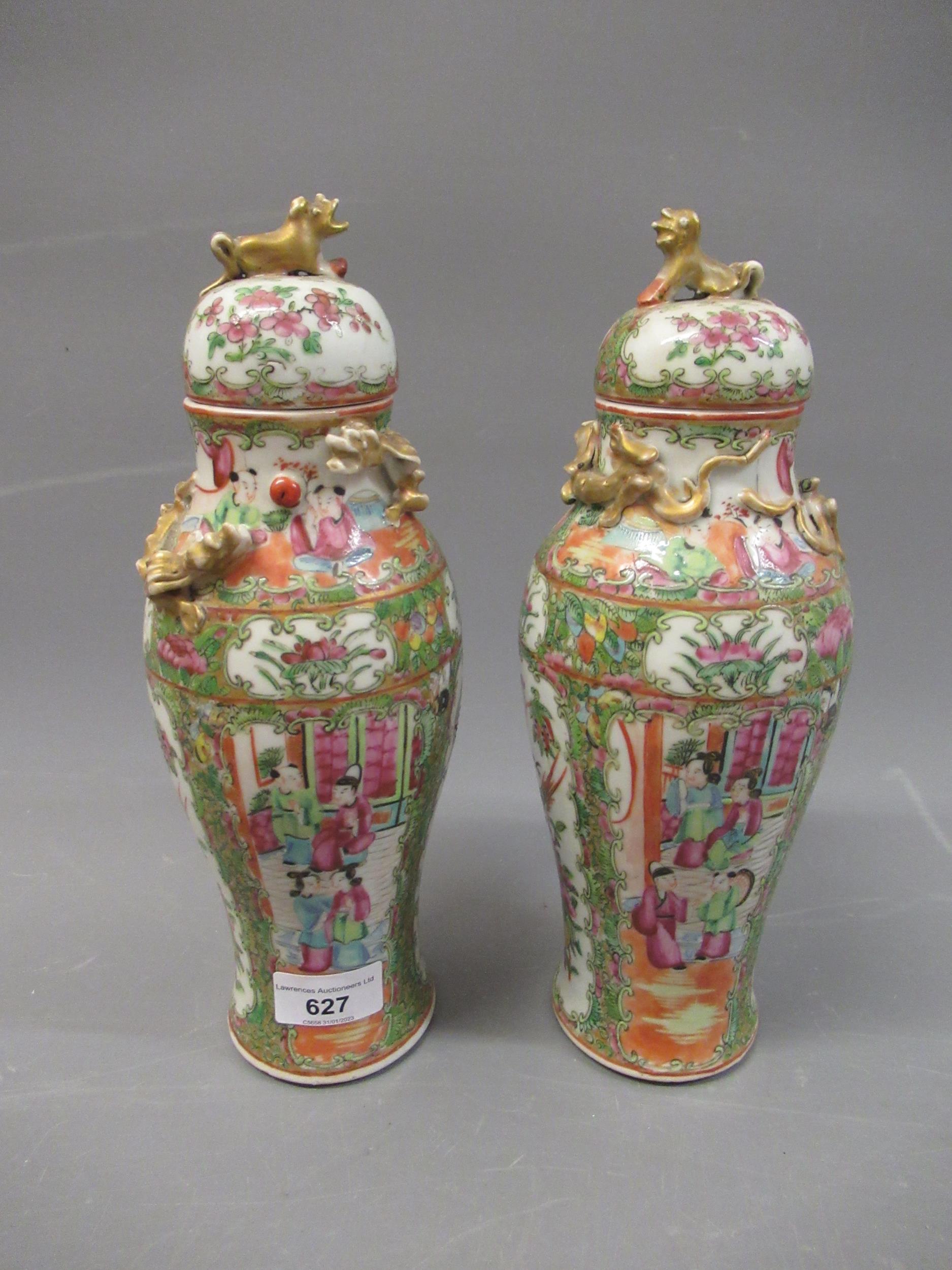 Pair of 19th Century Canton baluster form vases with covers decorated with panels of figures and