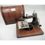 Lead Machine Continental child's sewing machine, housed in a dome case, (minus handle)