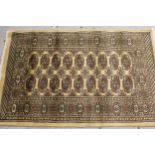 Pakistan Bokhara design rug with two rows of gols on a beige ground, 125cms x 82cms, together with