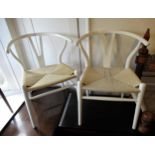 Pair of white lacquered wishbone type Charles Hansen style chairs with string seats, raised on