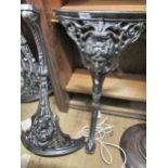 Two pairs of powder coated cast iron pub table legs with mask head decoration