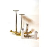 Two pairs of modern metal candle stands of stylised design and a brass five light candelabra