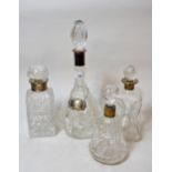 Group of four various silver mounted cut glass decanters, one with a silver label All in good