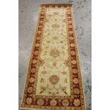 Indo Persian runner of Ziegler design with a palmette pattern on an ivory ground with borders,