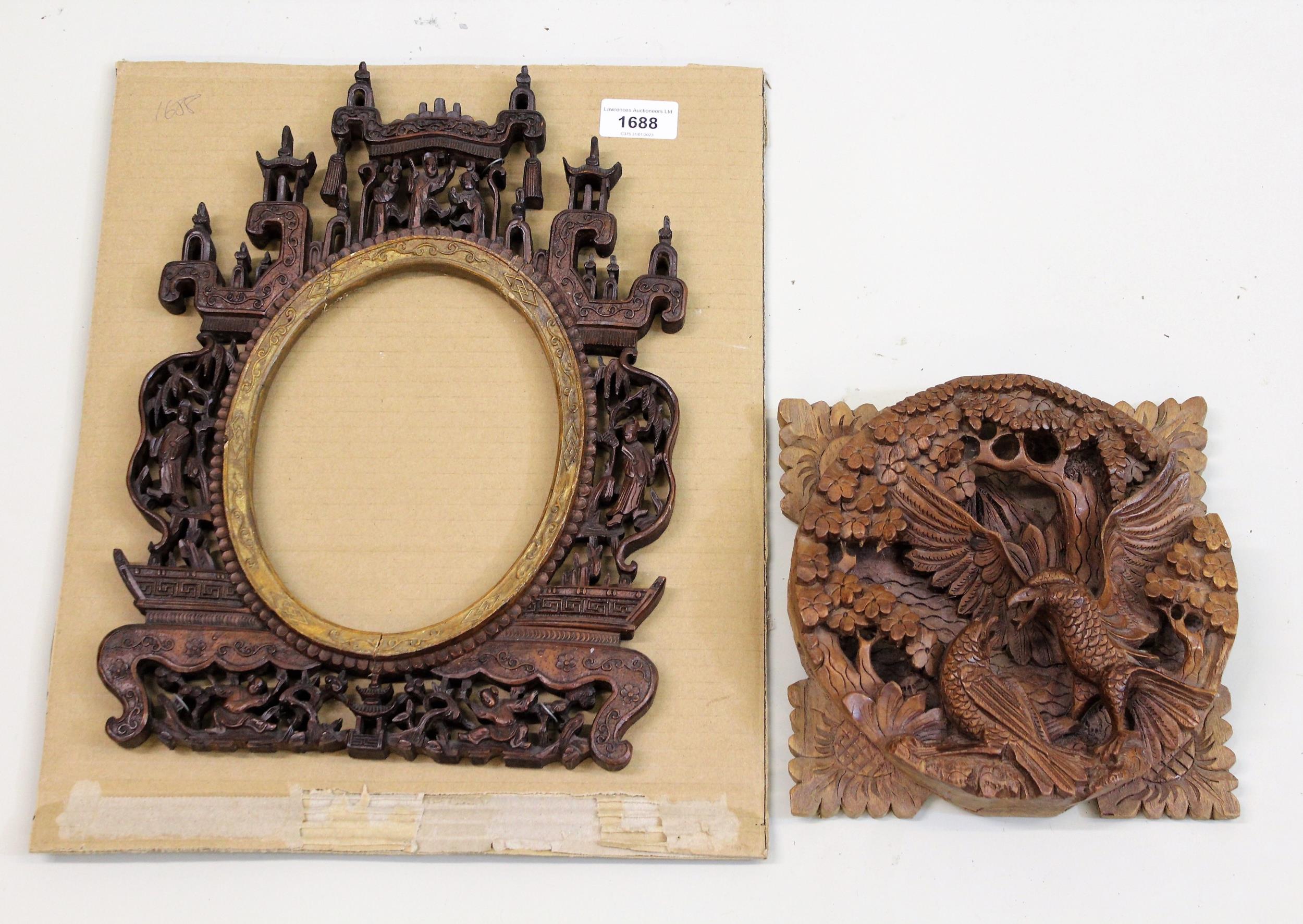 Chinese carved hardwood photograph frame with oval insert, 35cms x 26cms approximately overall,