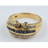 18ct Gold ring set a band of sapphires flanked by diamonds, 6g, size N