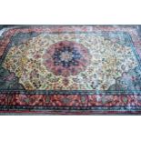 Indo Persian rug with a medallion and all-over stylised floral design in shades of deep blue, pink