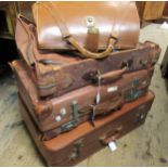 Two leather suitcases, two other suitcases and a briefcase