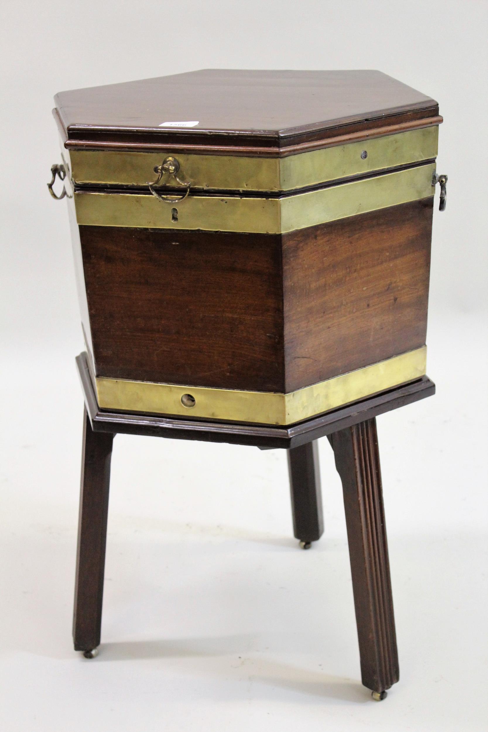 George III mahogany hexagonal brass bound wine cooler, on stand and with reeded supports, the hinged