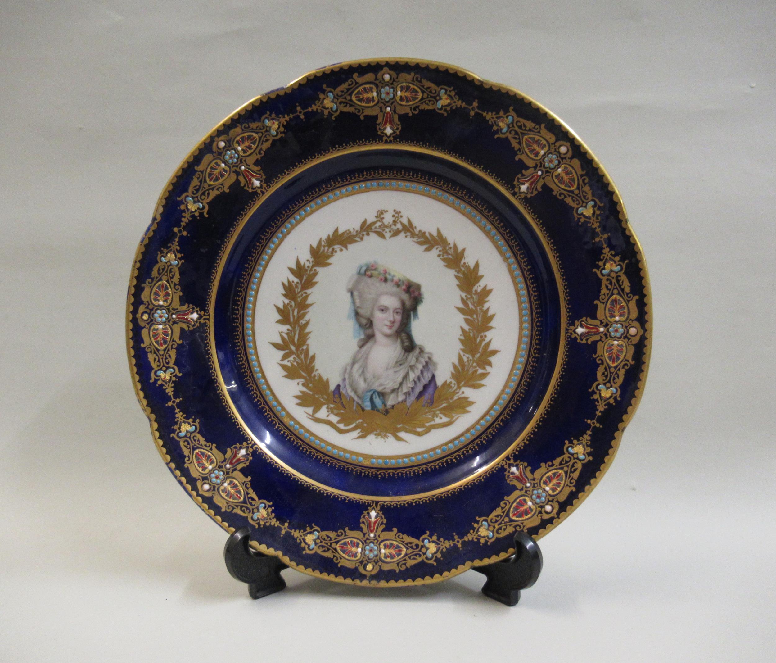 19th Century French porcelain plate, painted with a portrait of a lady within a dark blue and gilt