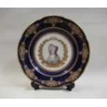 19th Century French porcelain plate, painted with a portrait of a lady within a dark blue and gilt