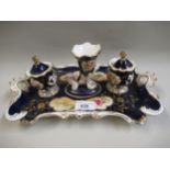 19th Century English porcelain inkstand with original central cornucopia quill holder flanked by two