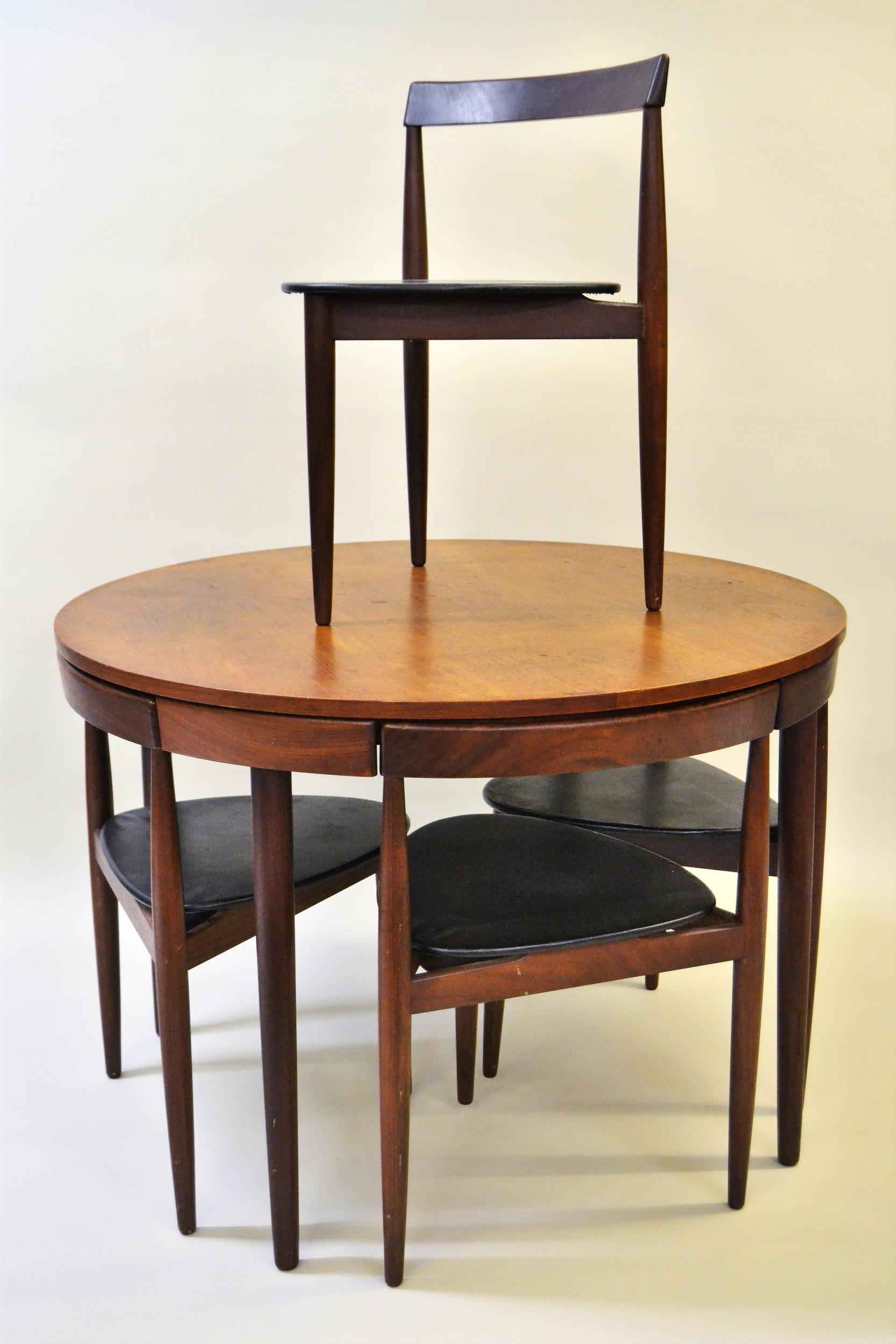 Frem Rojle, Danish teak circular dining table with four integral chairs on turned tapering supports,