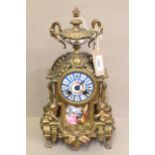 19th Century French gilt metal, porcelain mounted mantel clock, surmounted with an urn above a