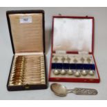 Cased set of twelve Continental gilded coffee spoons, another set of six white metal coffee spoons