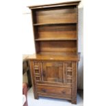 Small mid 20th Century oak dresser, the boarded shelf back above a base decorated with split