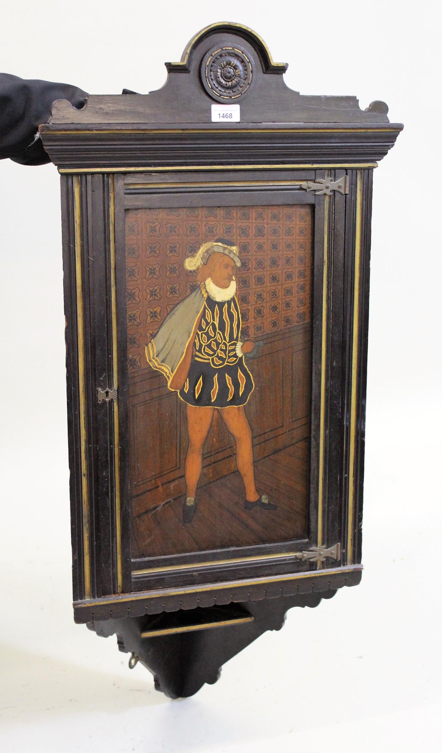 Late 19th Century ebonised and parcel gilt hanging corner cabinet, the door with painted