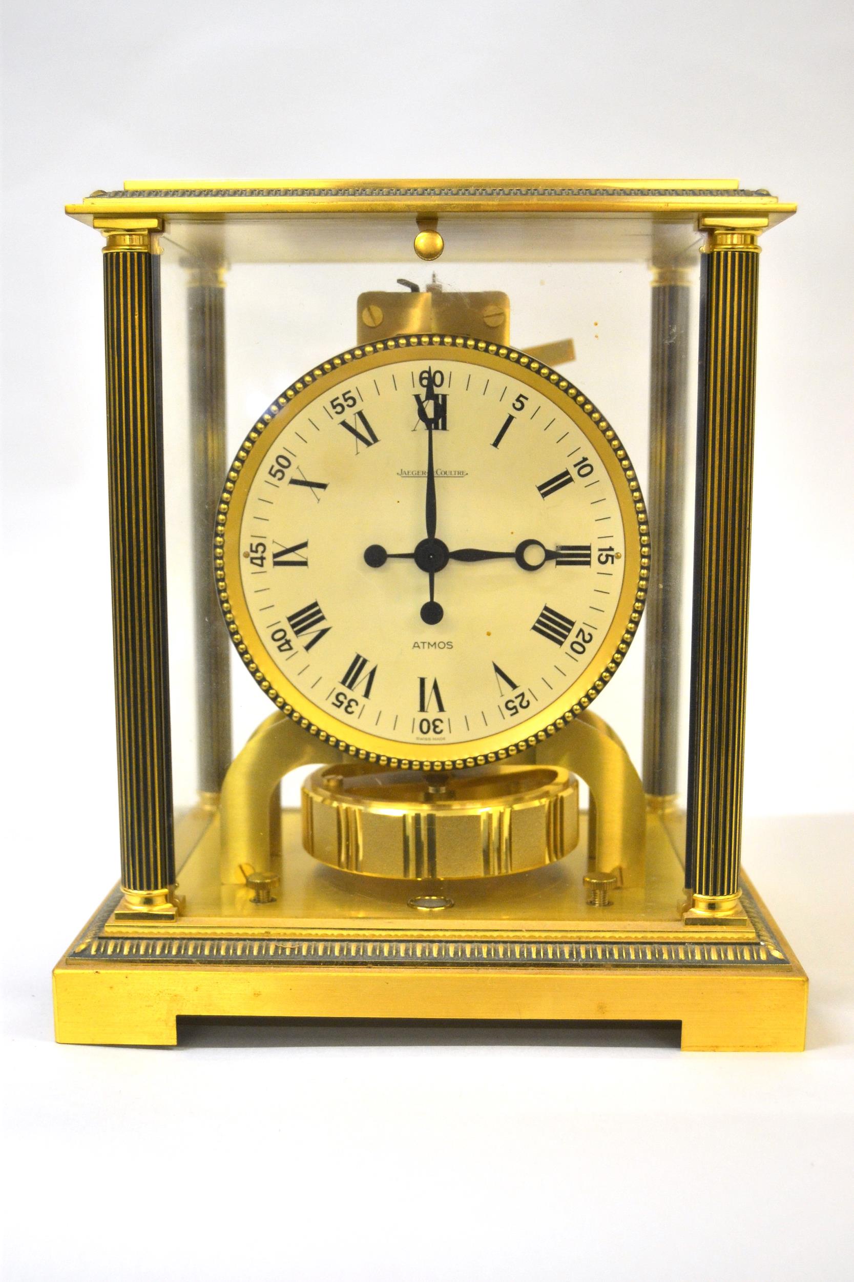 Jaeger Le-Coultre Atmos clock having glazed and gilt brass case, the circular white dial with