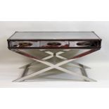 Andrew Martin, chrome and leather mounted three drawer side table on crossover supports, 153cms wide