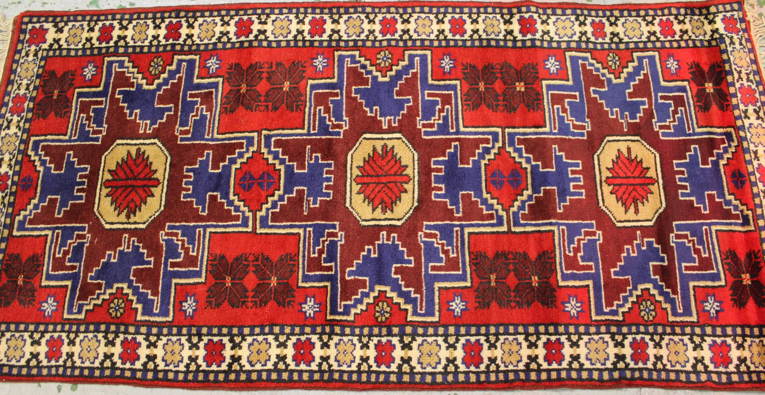 Small modern Turkish rug with a triple medallion design in shades of red and blue, 193cms x 98cms