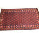 Modern Afghan Belouch rug with an all-over stylised design in shades of deep red and dark blue,