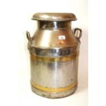 Steel and brass bound milk churn, 52cms high, together with a wrought iron and copper helmet