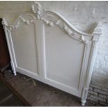 Mid 20th Century French white painted wooden double bedstead, the headboard with swag and wreath