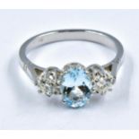 Platinum three stone claw set aquamarine and diamond ring, size 'O'