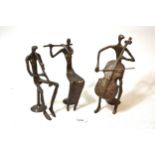 Group of three mid 20th Century dark patinated bronze figures of musicians in stylised form, the