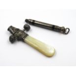 Silver mounted mother of pearl babies rattle / teether, together with a propelling pencil