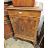 Mid 20th Century figured walnut side cabinet, the carved moulded top above a pair of panel doors