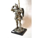 Silvered metal table lamp in the form of a classical warrior with sword and shield, mounted on a