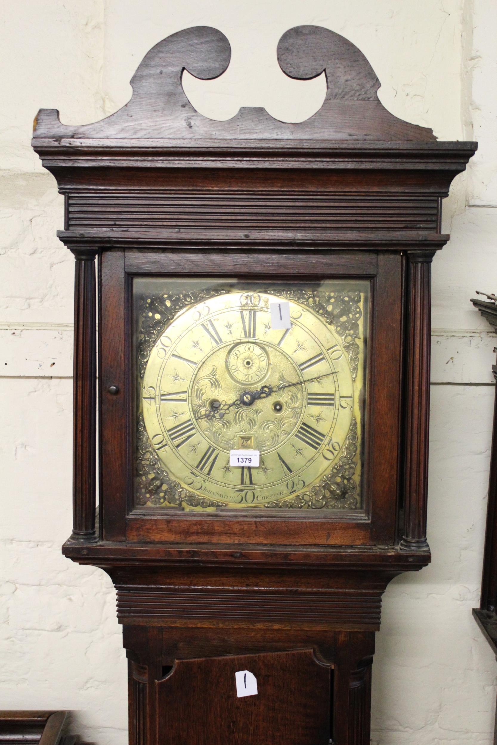 George III oak longcase clock, the square hood with swan neck pediment above a shaped door, the