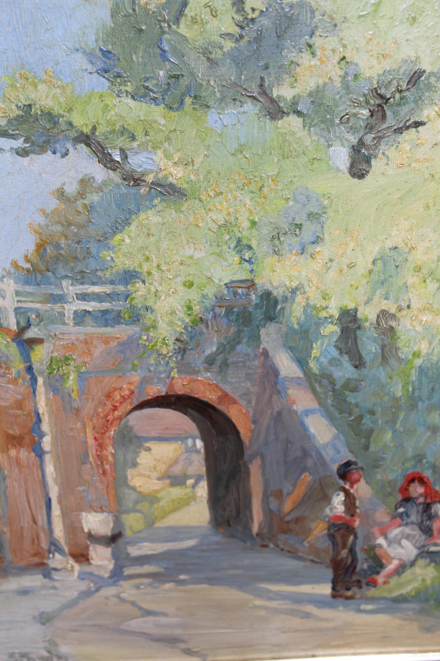 E. Stamp, signed oil on canvas board, landscape with two figures near a bridge, 33cms x 24cms