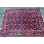 Sarouk Mahal carpet with an all-over stylised flower head design, on a midnight blue ground with