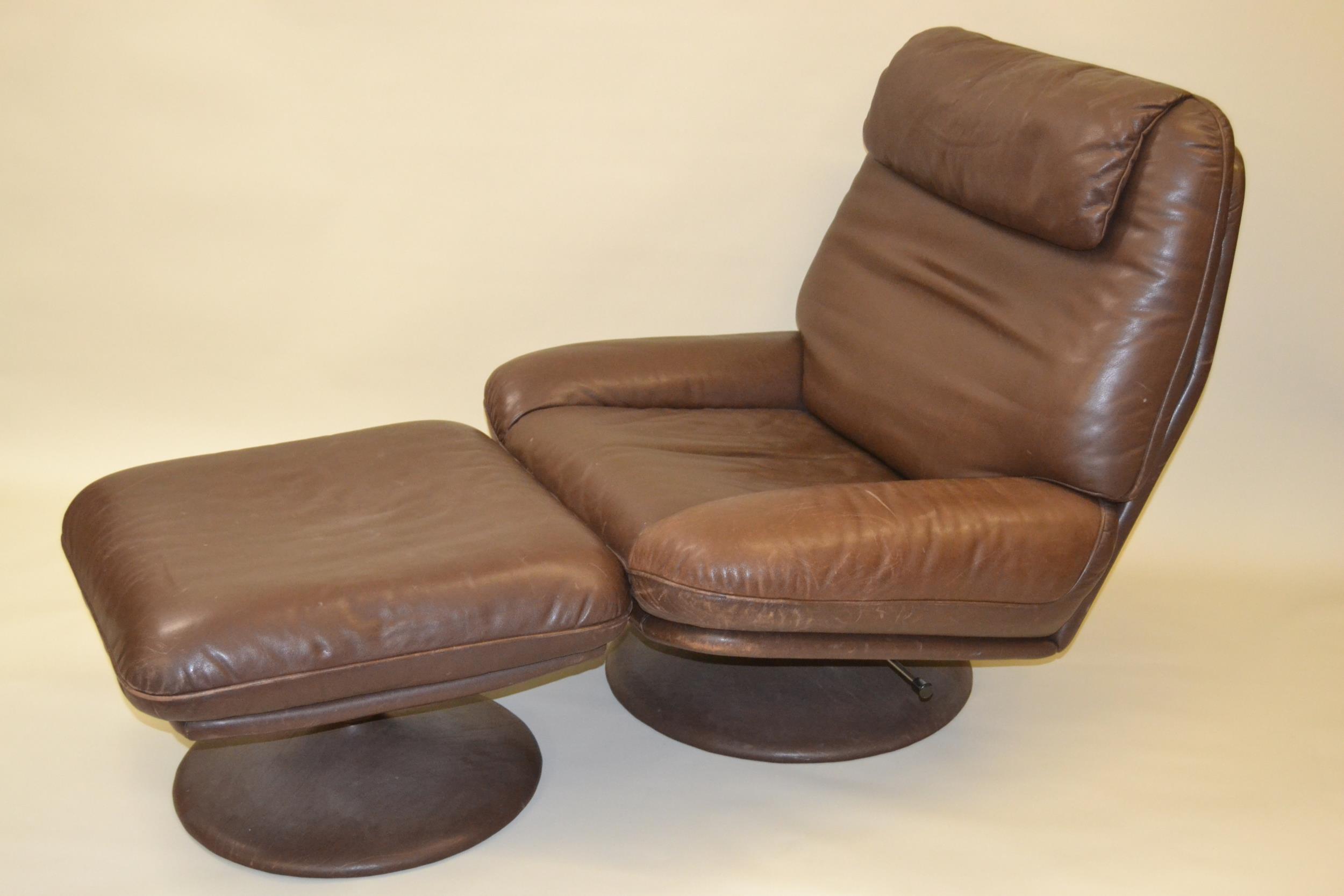 1970's De Sede dark tan leather swivel chair with matching stool