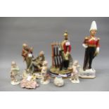Two Continental porcelain figures of Napoleonic soldiers, Capo di Monte group of two gentlemen,