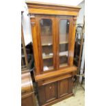 Small Victorian mahogany bookcase with two glazed doors, above a drawer and pair of panelled
