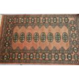Small Pakistan Bokhara design rug with pink ground, 128cms x 76cms together with a similar,