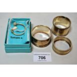 Tiffany & Co. napkin ring in the form of a golf club, and three various silver napkin rings