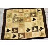 Small flatweave rug woven with a stylised bird design in shades of cream, beige and brown, 145cms