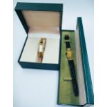 Two ladies gilt metal Gucci watches in original boxes Watch with leather strap is working although