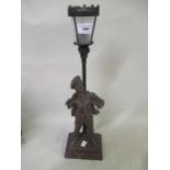 Early 20th Century patinated spelter table lamp, in the form of a street urchin under a street lamp,