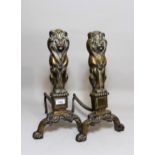 Pair of brass lion motif fire dogs, 45cms high