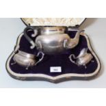 Cased Birmingham silver three piece tea service with ebonised handle by Walker & Hall, 24oz t