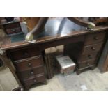 Mahogany twin pedestal desk, the green rexine inset top above eight drawers with knob handles on
