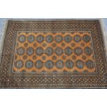 Afghan gold ground carpet with three rows of eight gols within a multiple border, 290cms x 210cms