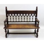 19th Century oak hall bench with an arcaded and spindle back above a moulded panel seat and baluster