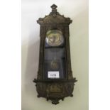Unusual miniature brass and ebonised Vienna type wall clock, the engraved brass dial with Roman