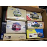 Box containing a collection of Corgi classic diecast model buses in original boxes, including some